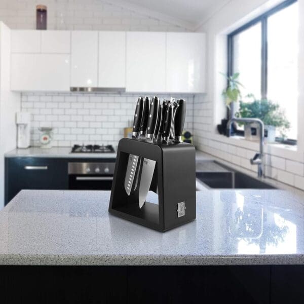 A kitchen counter with many knives on it