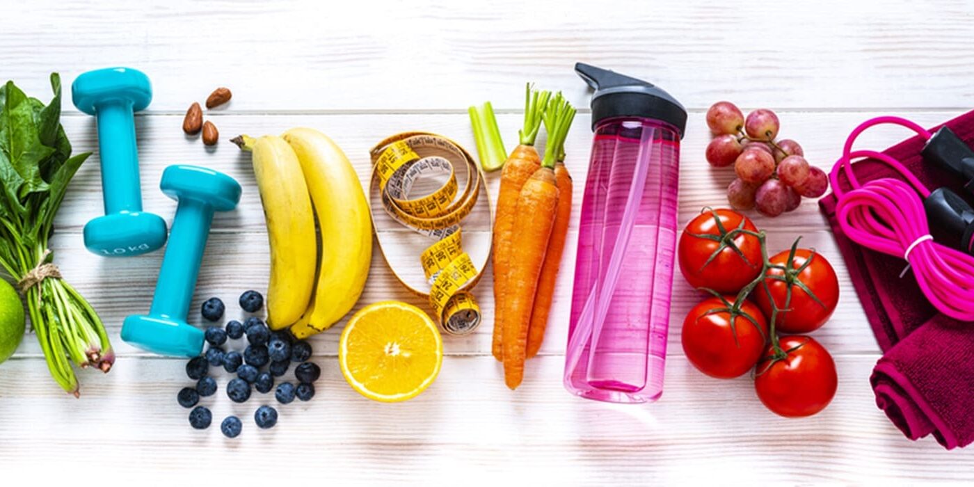 A wooden table topped with fruits and vegetables.